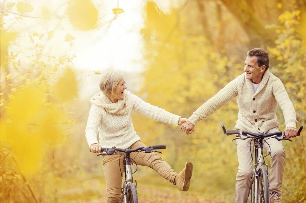 senior could riding bicycles in autumn.