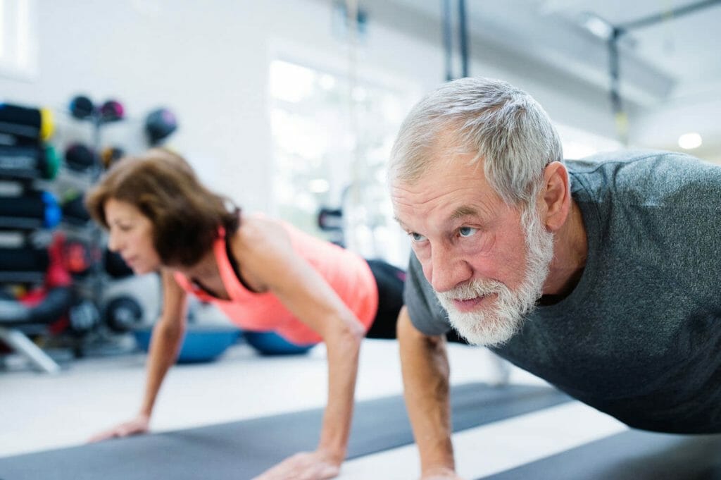 image of a senior couple working out in a gym