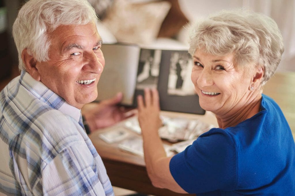 senior couple looking at a photo album