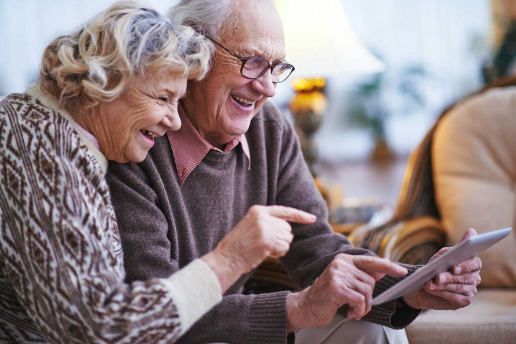 senior couple looking at a tablet