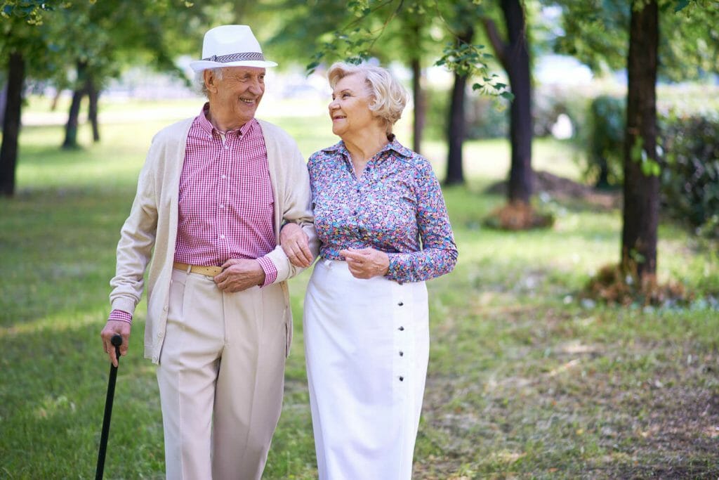 a senior couple taking a walk in the park together