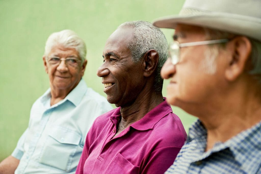 3 older men sitting together, just hanging out.